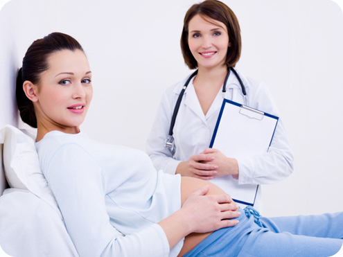 Beautiful smiling pregnant woman with the doctor at hospital